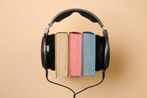 a pair of headphones over 3 books 
