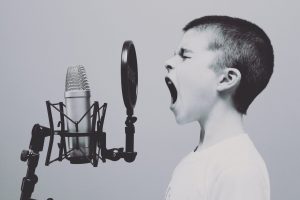A child screaming into a microphones