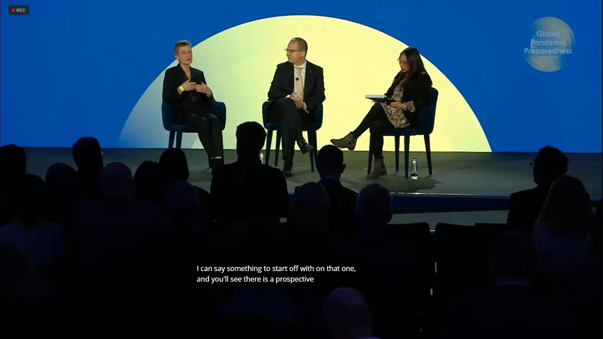 Live captions showing on the screen at an event with panel speakers